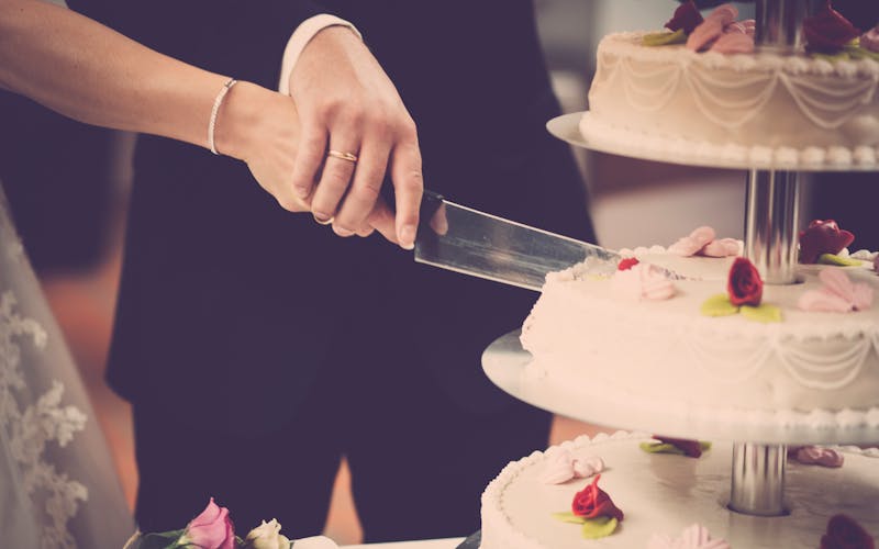 A couple cutting their wedding cake